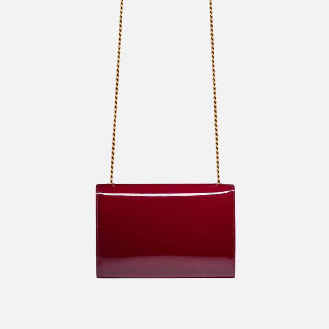 Petit sac SL Kate porté à l’épaule en cuir verni